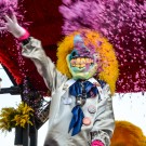 Waggis throwing paper confetti at carnival spectators